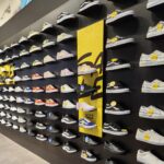 Shoes on display in a shoe store using Dinya slatwalls and accessories.